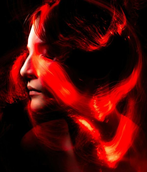 Woman in a dynamic cardio pose, full of energy against a dark background.